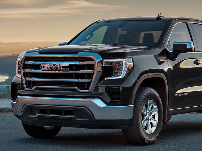 Front facing view of black GMC Sierra 1500 in front of mountains